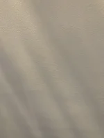 Marks when bright light shines down artex wall ?