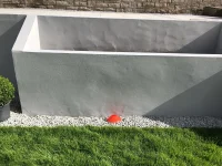 Bumps appeared in rendered retaining garden planter wall.