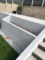 Bumps appeared in rendered retaining garden planter wall.