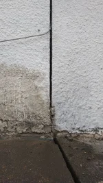 Penetrating damp / stain on joining wall just below porch roof