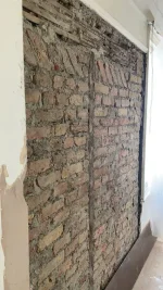 Damp patch on newly plastered wall