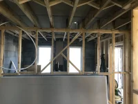 Plasterboard covering herringbone struts