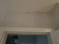 Small cracks top of wall just below ceiling