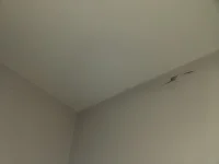 Small cracks top of wall just below ceiling